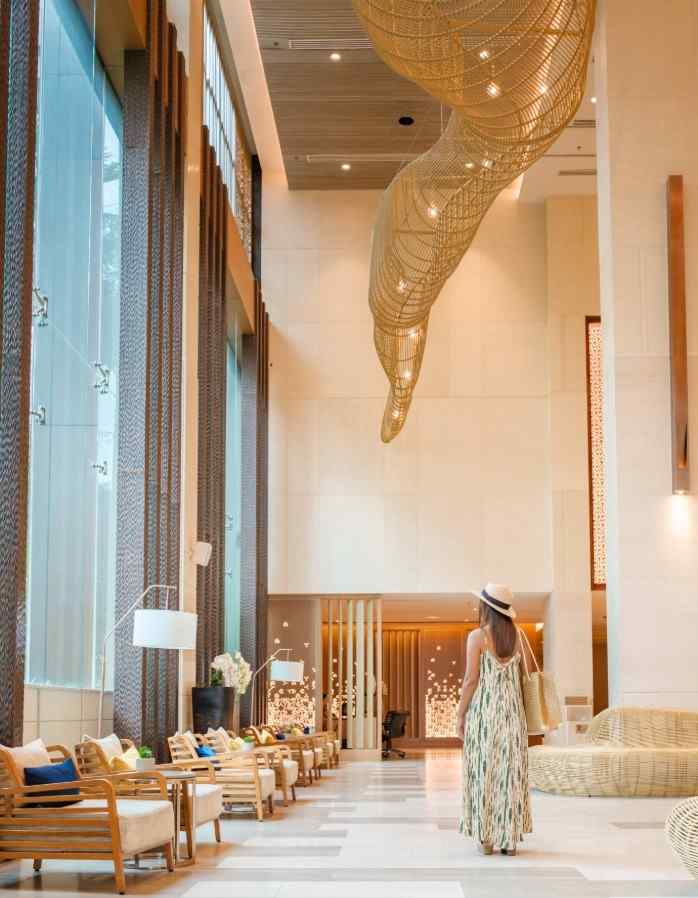 Tall hospitality lounge with a suspended woven light sculpture