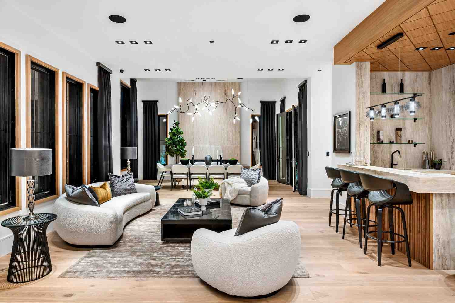 Open-plan living room and kitchen with a marble island and bar stools