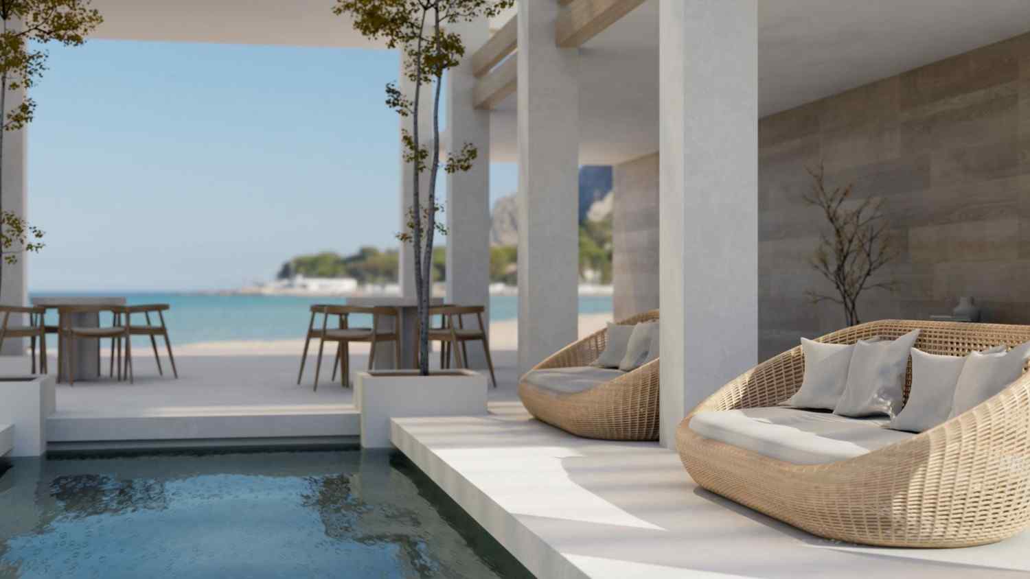 Shaded terrace with outdoor seating and a pool overlooking the sea