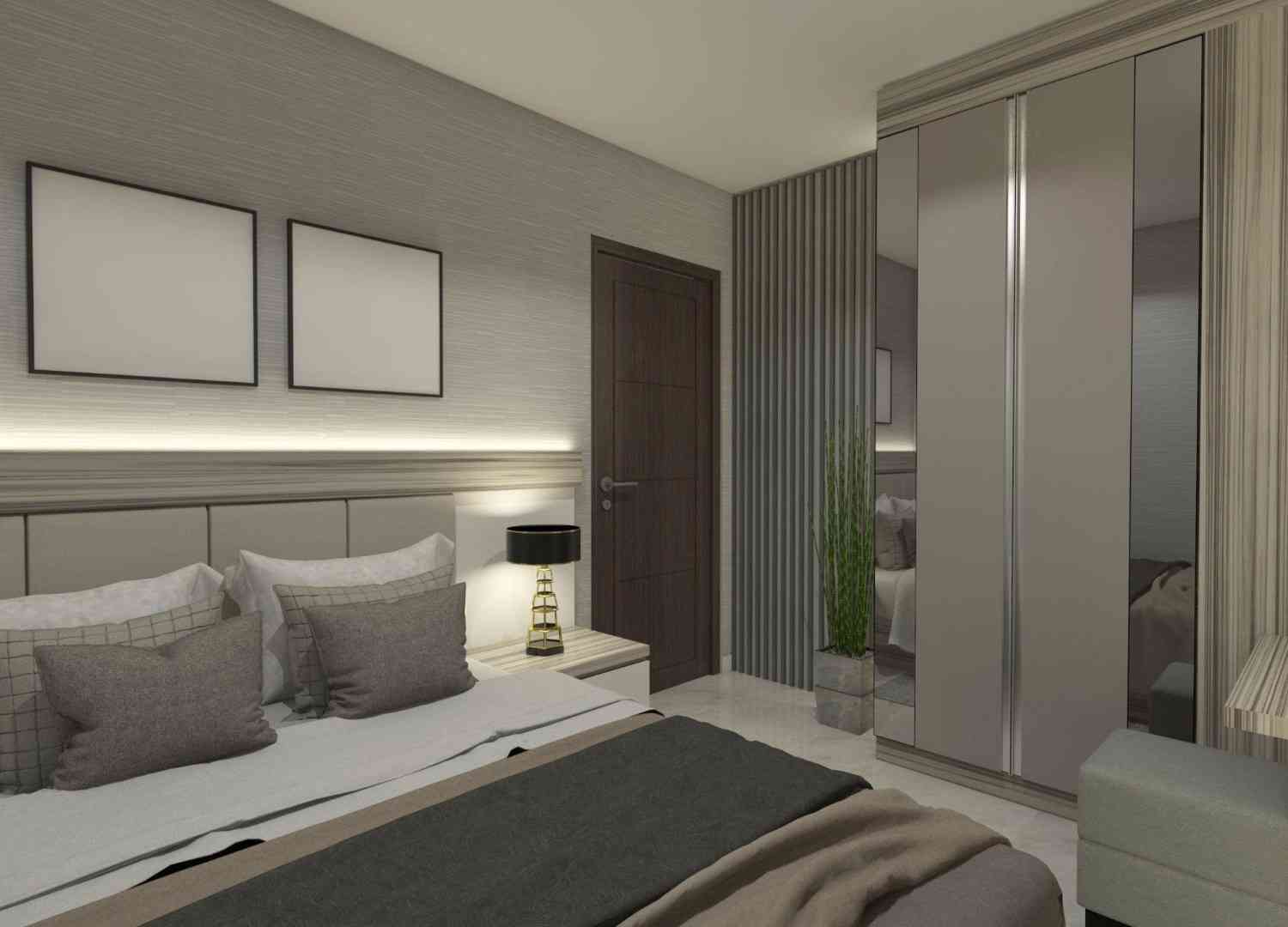 Calm bedroom with grey upholstery, framed art and a wardrobe wall