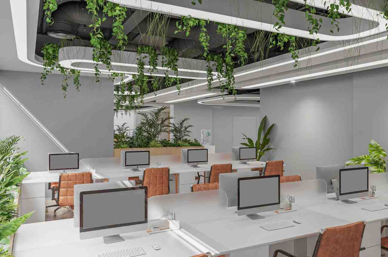 Open-plan office with planted ceiling features and rows of desks