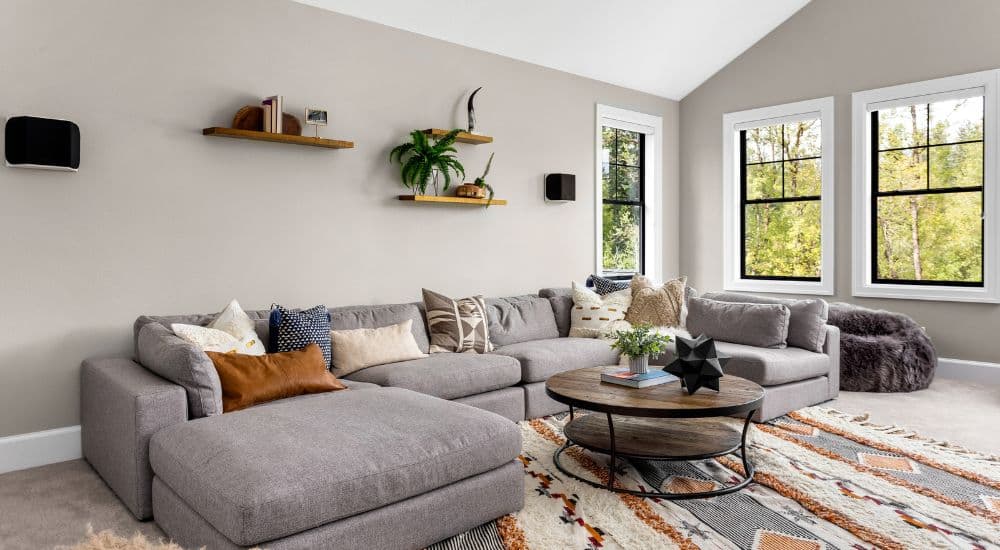 Living room with a grey sectional sofa and a patterned rug